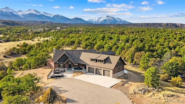 aerial view featuring a mountain view and a view of trees