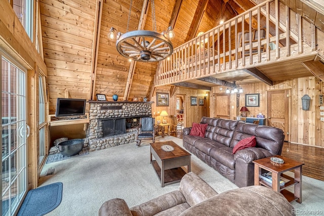 16495 Mt Princeton Rd, Buena Vista, CO 81211 - living room with wood walls, wooden ceiling with exposed beams, high vaulted ceiling, a chandelier, and carpet