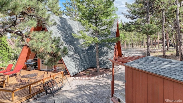 16495 Mt Princeton Rd, Buena Vista, CO 81211 - view of side of home featuring roof with shingles and a wooden deck