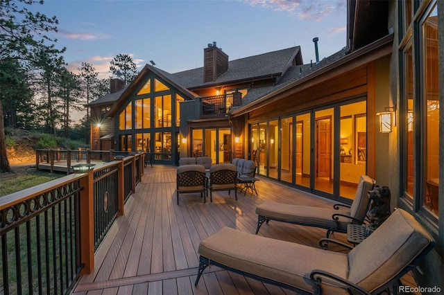 deck at dusk with outdoor lounge area