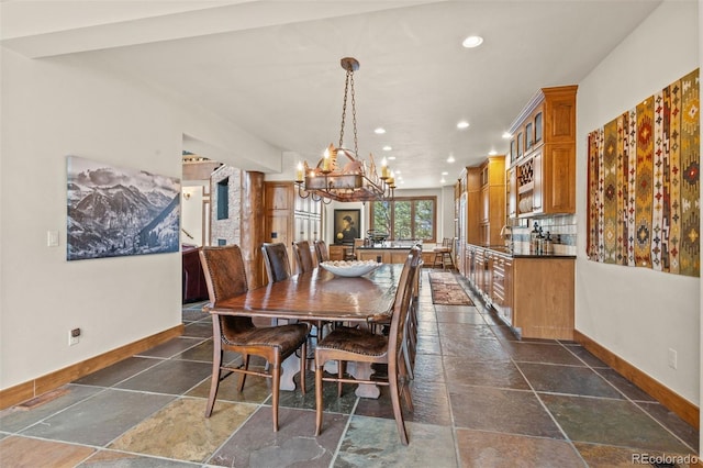 dining space with a chandelier and sink