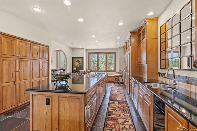 kitchen featuring a center island with sink and sink