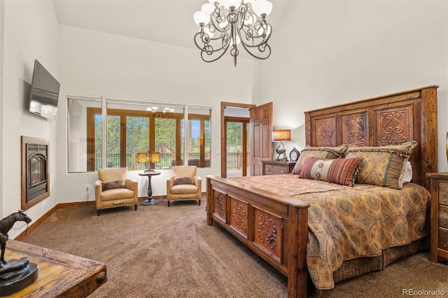 bedroom featuring access to exterior, carpet, an inviting chandelier, and a high ceiling