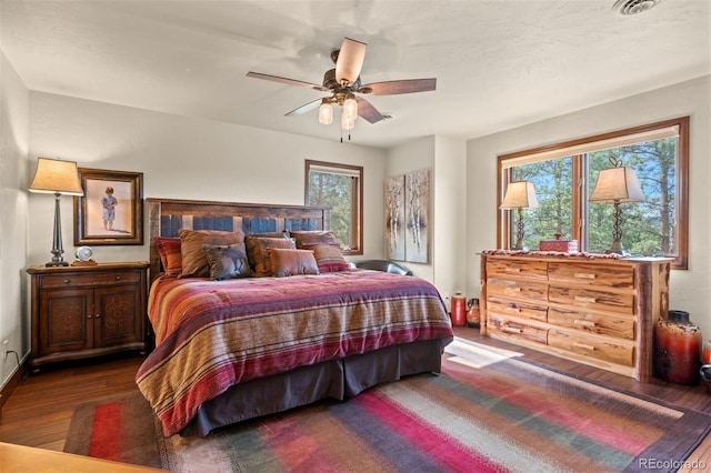 bedroom featuring ceiling fan and dark wood-type flooring