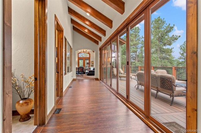 unfurnished sunroom featuring french doors and lofted ceiling with beams