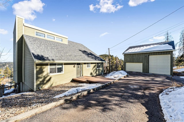 view of front of property with a garage and an outbuilding