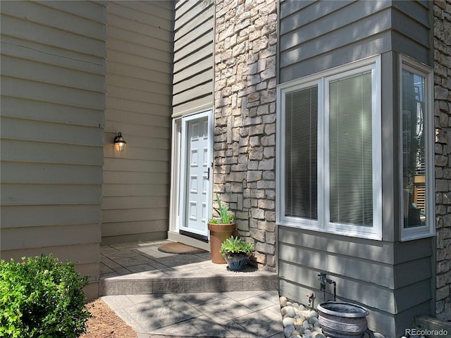 view of exterior entry with stone siding