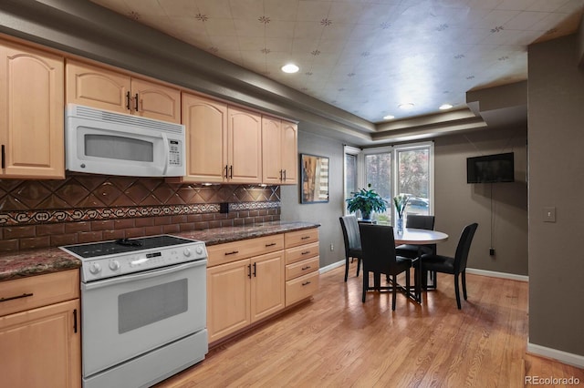 kitchen featuring light wood-style floors, white appliances, and light brown cabinets