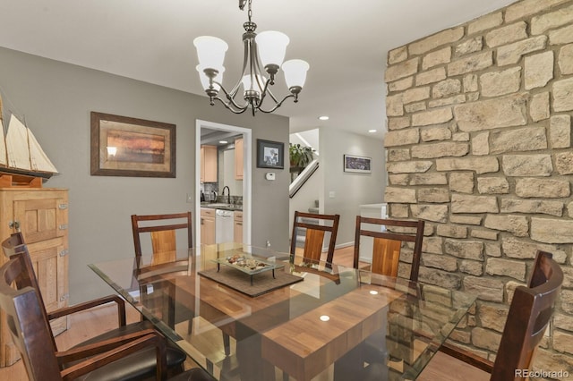 dining area with light wood finished floors, baseboards, a chandelier, and recessed lighting