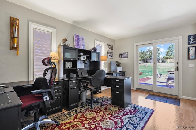 office space featuring baseboards, wood finished floors, and french doors