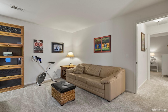 living area with carpet, visible vents, and baseboards