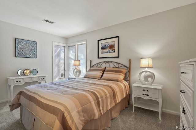 bedroom with carpet floors, visible vents, and baseboards