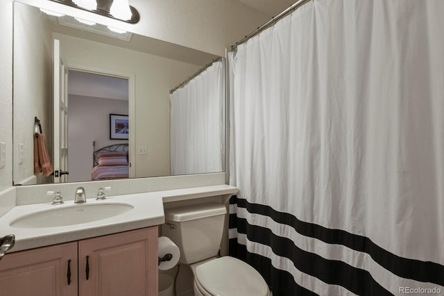 bathroom featuring toilet and vanity