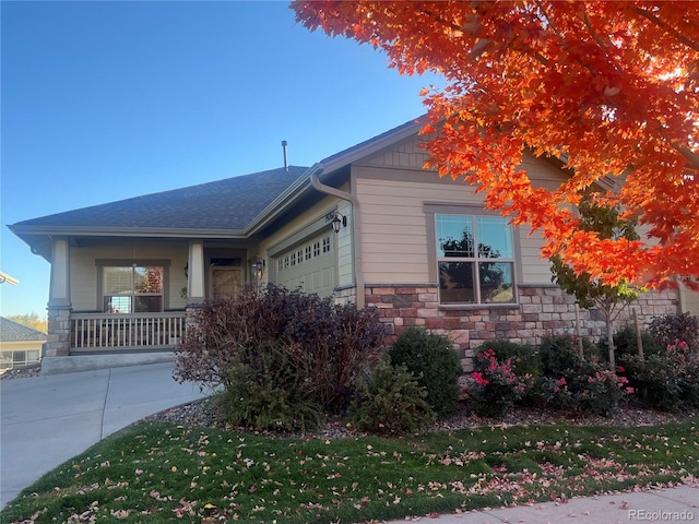 view of front facade featuring a porch and a garage