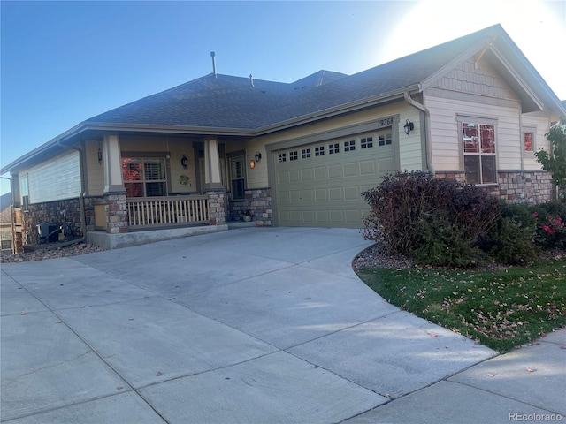 view of front of house with a porch and a garage