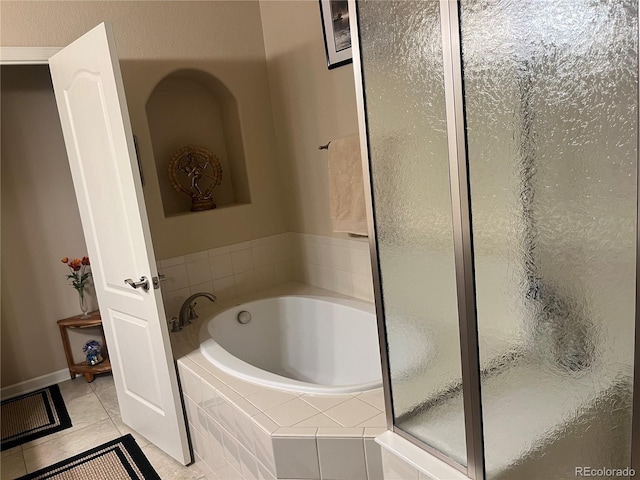 bathroom with plus walk in shower and tile patterned flooring