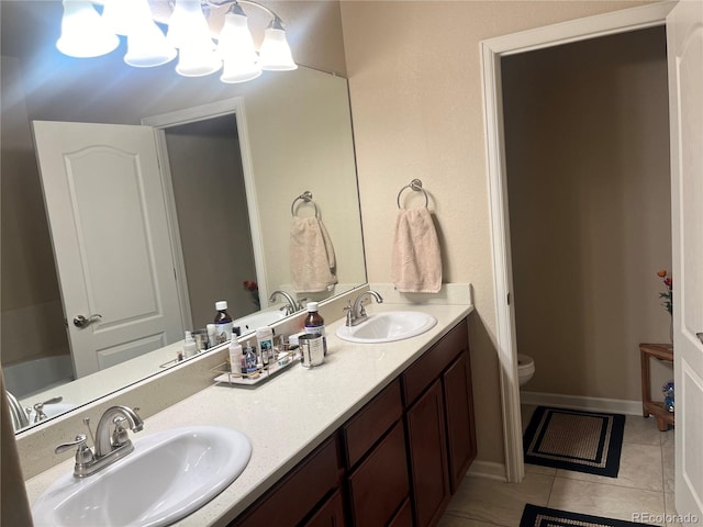 bathroom featuring vanity, toilet, and tile patterned floors