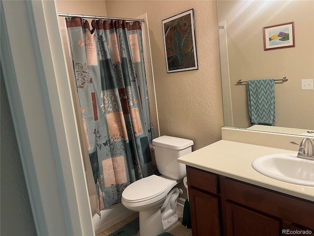 bathroom featuring toilet, walk in shower, and vanity