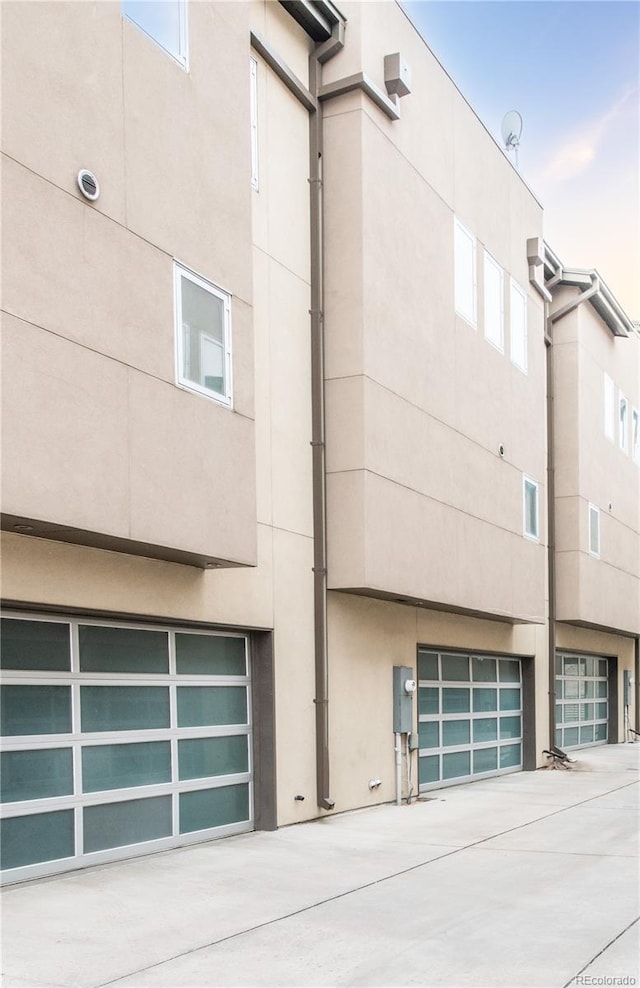 exterior space featuring stucco siding and an attached garage