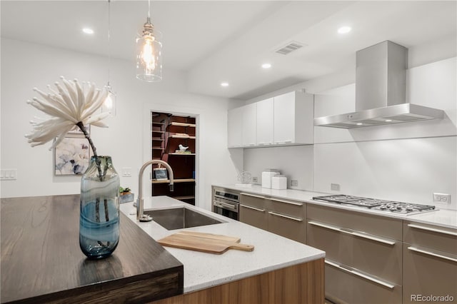 kitchen with extractor fan, stainless steel appliances, a sink, modern cabinets, and recessed lighting