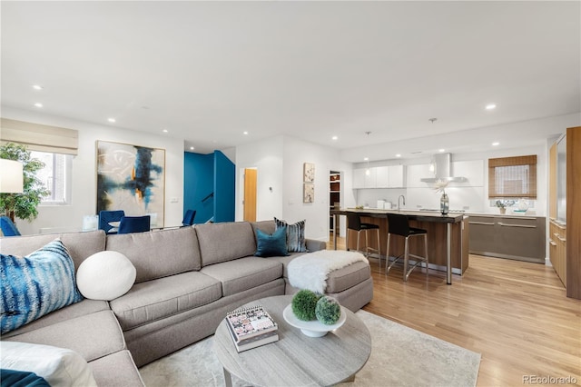 living room with recessed lighting and light wood-style floors