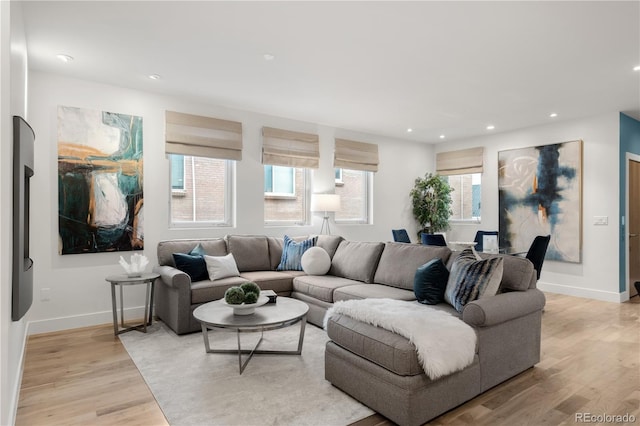 living area with light wood finished floors, recessed lighting, and baseboards