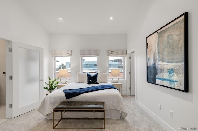 bedroom featuring light carpet, recessed lighting, and baseboards