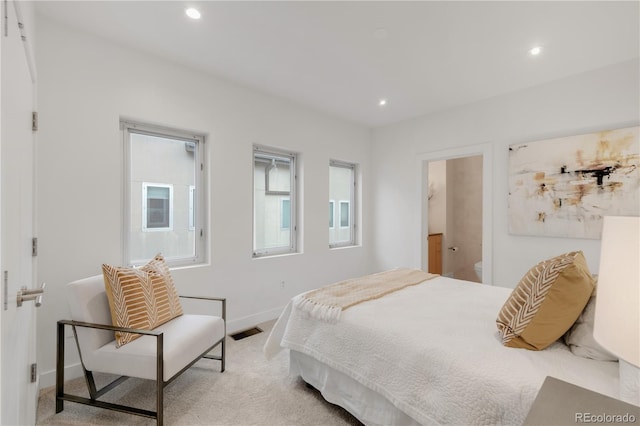 bedroom with recessed lighting, light colored carpet, and baseboards