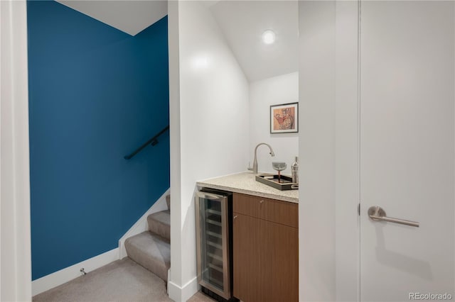 2314 S University Blvd, Denver, CO 80210 - indoor wet bar featuring beverage cooler, light carpet, baseboards, lofted ceiling, and stairway