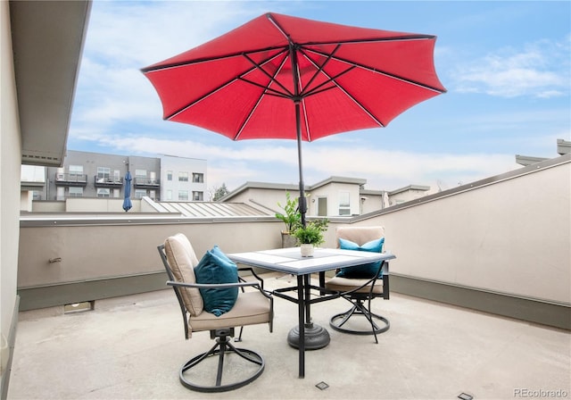 view of patio featuring outdoor dining space and a balcony