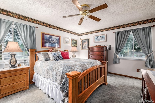 bedroom featuring ceiling fan, a textured ceiling, light carpet, and multiple windows