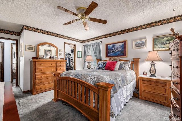 bedroom featuring ceiling fan and a textured ceiling