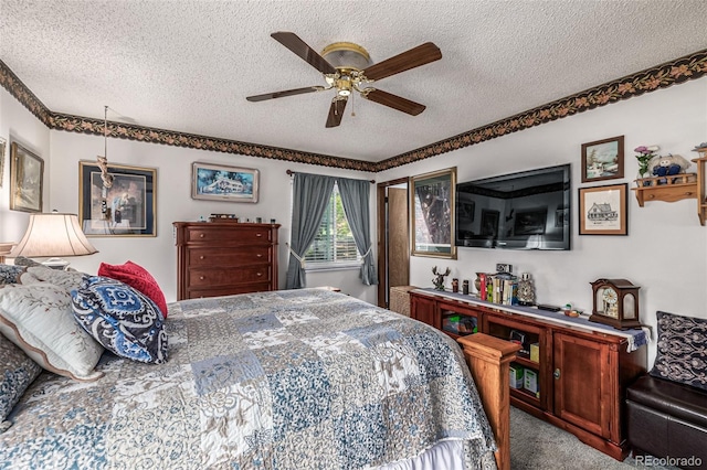 carpeted bedroom featuring ceiling fan and a textured ceiling