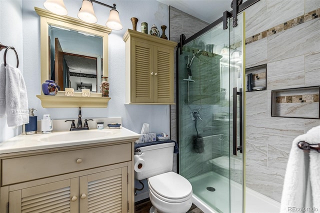 bathroom with toilet, vanity, and walk in shower