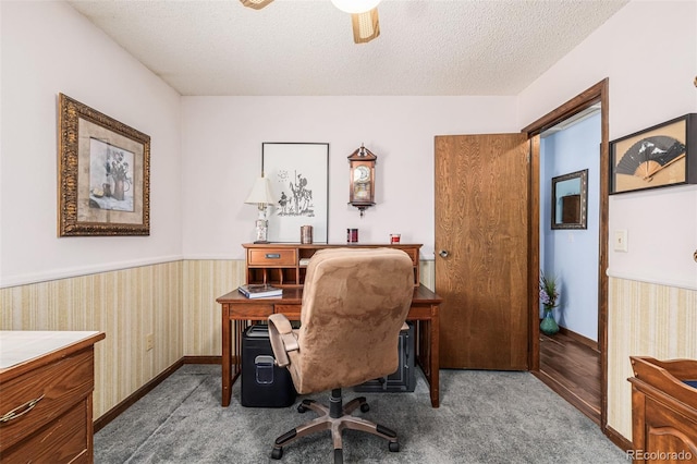 office space featuring ceiling fan, carpet floors, and a textured ceiling