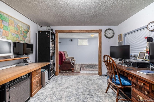 office area with light colored carpet and a textured ceiling