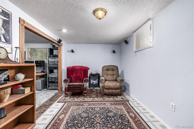 sitting room featuring a textured ceiling