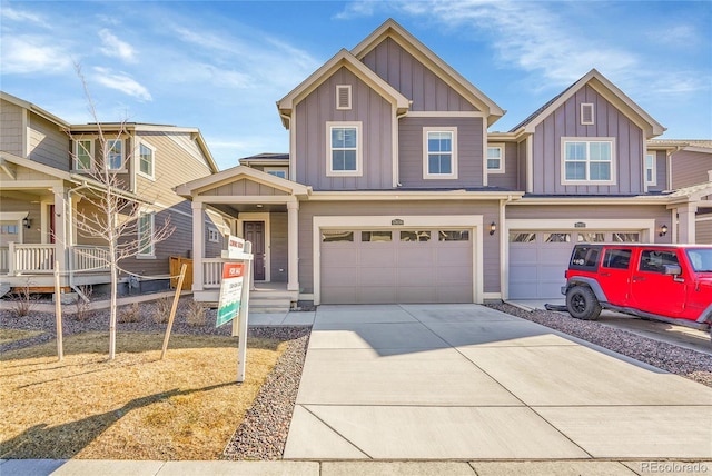 craftsman-style house with a garage, concrete driveway, and board and batten siding