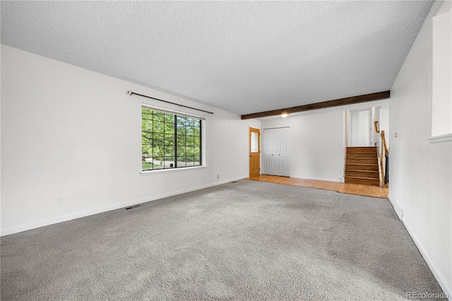 19398 E Eastman Pl, Aurora, CO 80013 - carpeted spare room featuring stairs, a textured ceiling, baseboards, and beamed ceiling