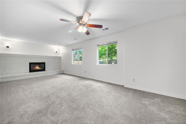 19398 E Eastman Pl, Aurora, CO 80013 - unfurnished living room with a brick fireplace, a ceiling fan, carpet flooring, and baseboards