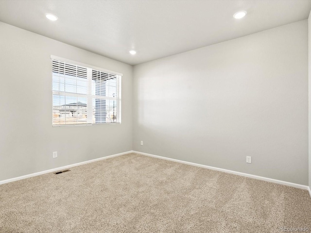 unfurnished room with baseboards, visible vents, carpet flooring, and recessed lighting