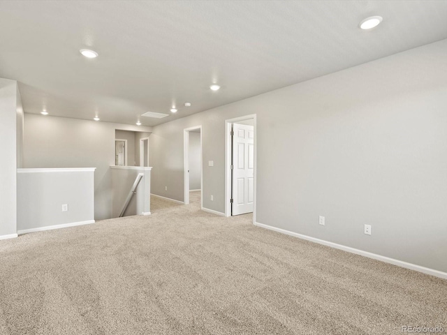 empty room with baseboards, recessed lighting, and light colored carpet