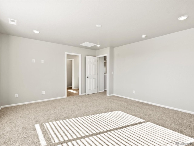 unfurnished room with carpet, baseboards, and visible vents