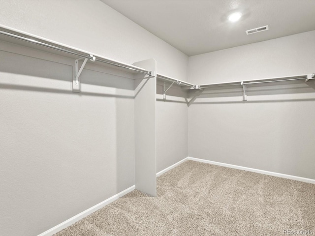 walk in closet with carpet floors and visible vents