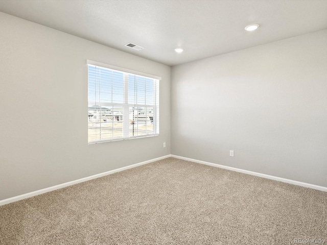 carpeted empty room with recessed lighting, visible vents, and baseboards