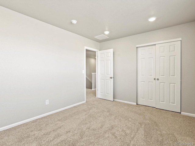 unfurnished bedroom featuring visible vents, baseboards, carpet floors, a closet, and recessed lighting