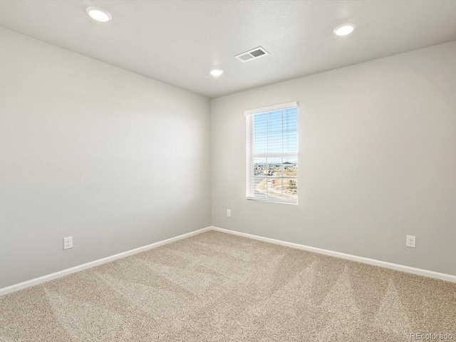 carpeted spare room with recessed lighting, visible vents, and baseboards