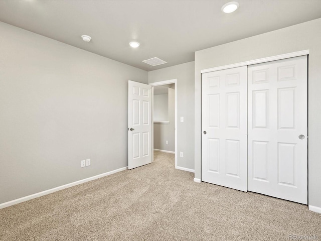 unfurnished bedroom featuring recessed lighting, visible vents, baseboards, a closet, and carpet