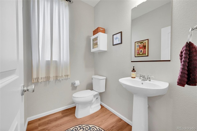 bathroom featuring sink, hardwood / wood-style floors, and toilet