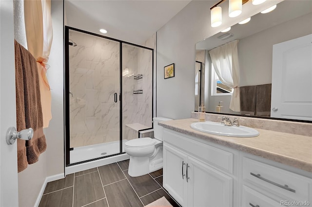 bathroom with vanity, an enclosed shower, and toilet